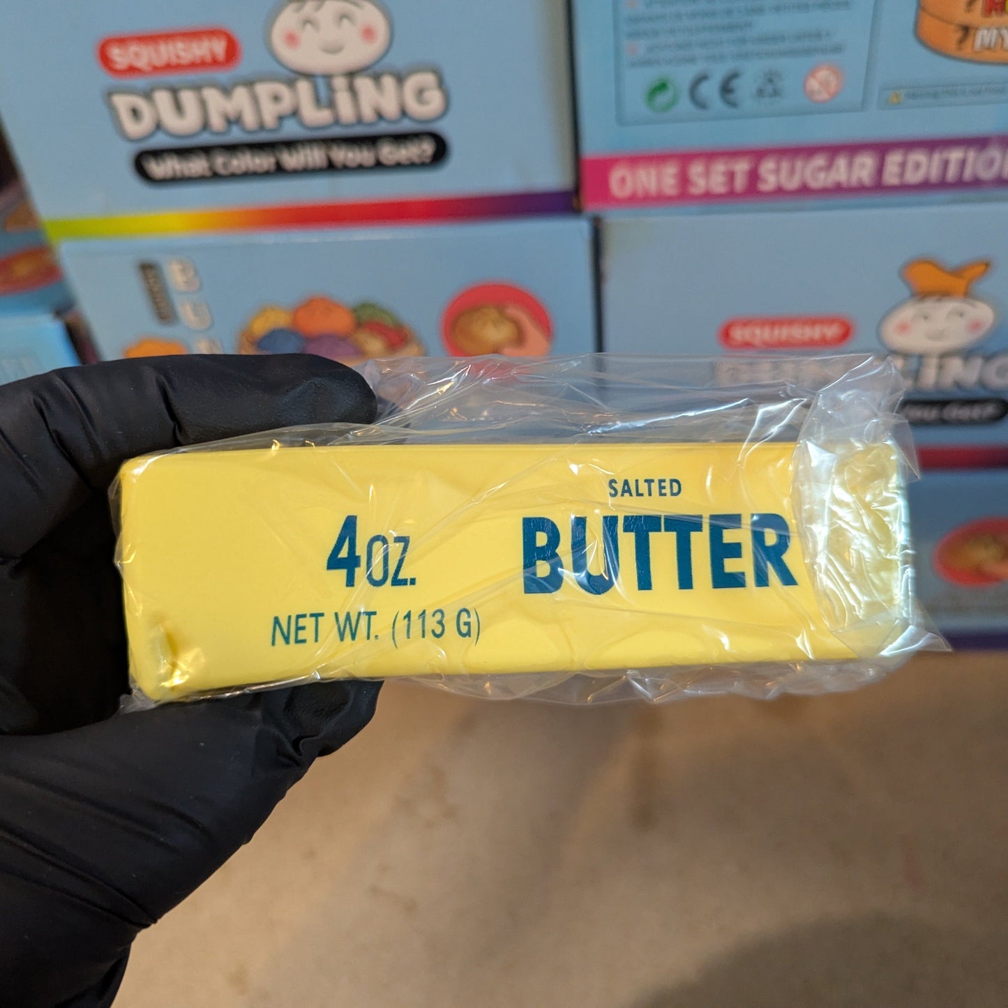 Small Ralphie's Funhouse butter-scented squishy toy, soft and squeezable, resembling a stick of butter.
