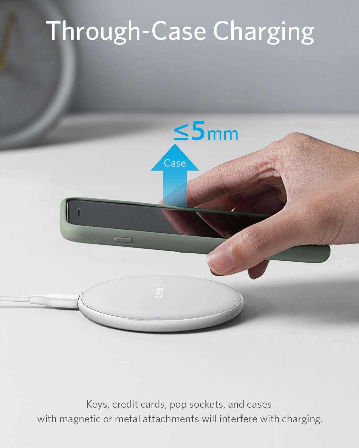 Black Anker 313 wireless charging pad for charging compatible devices wirelessly on a sleek, minimalist surface.
