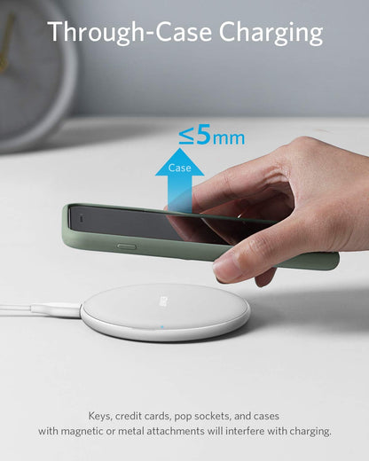 Black Anker 313 wireless charging pad for charging compatible devices wirelessly on a sleek, minimalist surface.