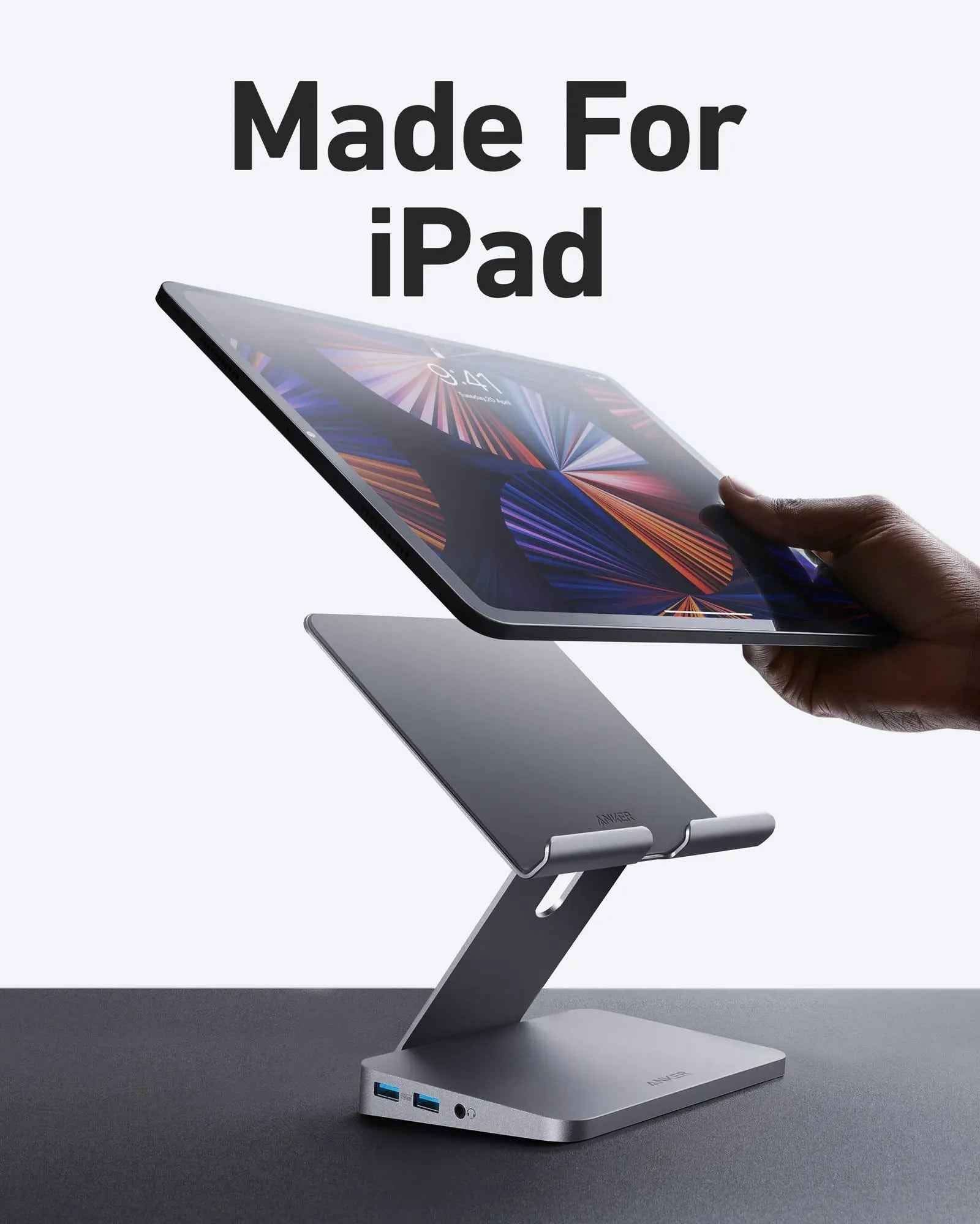 Anker 551 USB-C Hub in gray with tablet stand, showing multiple ports for charging and connectivity in a compact design.