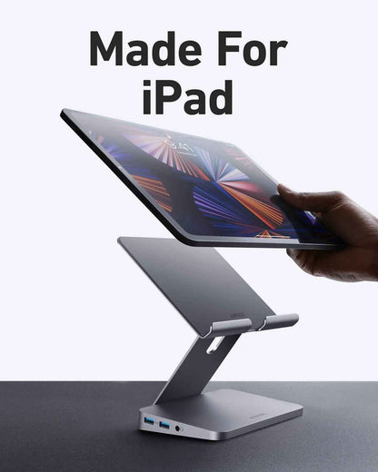 Anker 551 USB-C Hub in gray with tablet stand, showing multiple ports for charging and connectivity in a compact design.