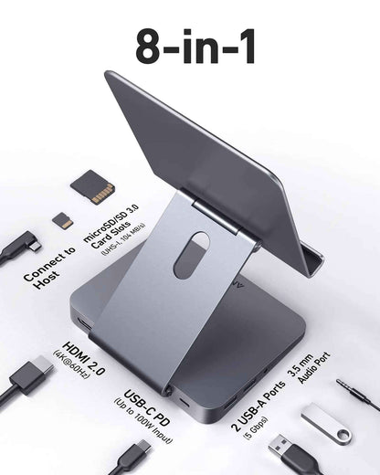 Anker 551 USB-C Hub in gray showing multiple ports and a tablet stand for charging and connectivity.