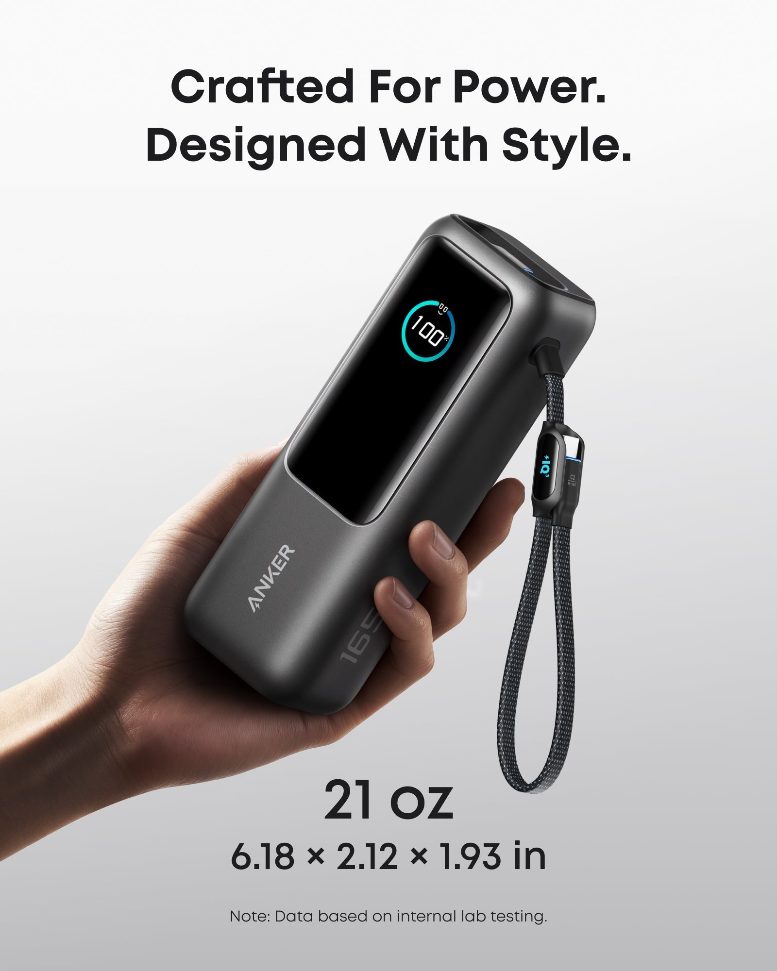 Anker 25K 165W black laptop power bank with built-in and retractable cables for portable charging.