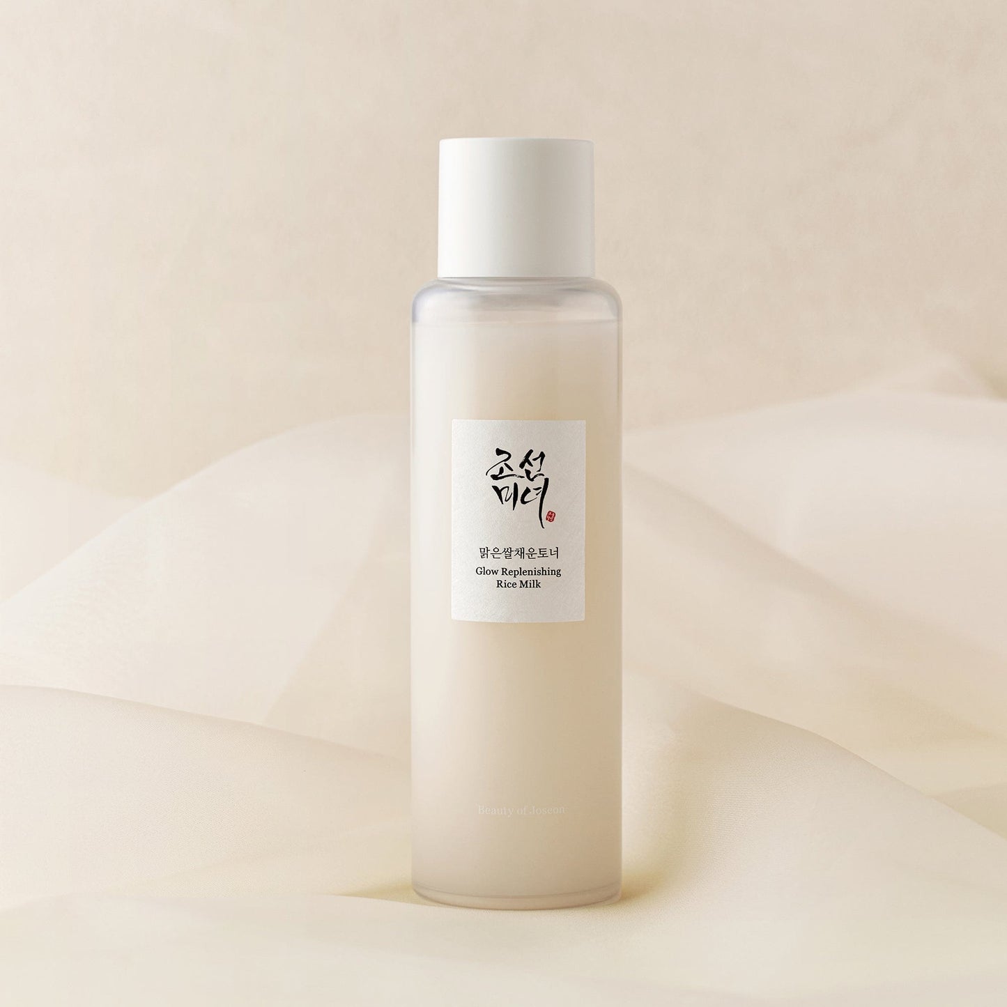 Beauty Of Joseon Glow Replenishing Rice Milk toner lotion in a clear bottle with white and gold label, showing rice grain design.