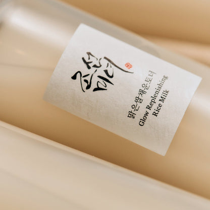 Beauty of Joseon Glow Replenishing Rice Milk toner lotion in a clear bottle with a white and gold label, designed for nourishing skin.