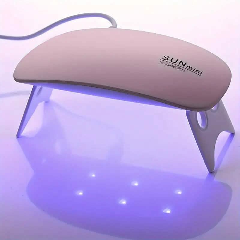 Mini UV/LED nail dryer with three LED lights, compact design, for quick and efficient nail curing in beauty and personal care.