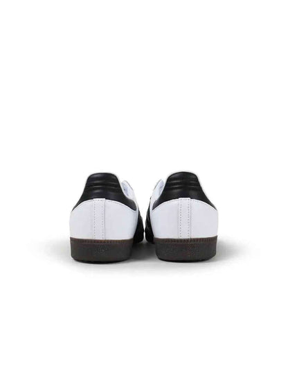 Men's Adidas Samba OG sneakers in classic white and black, showcasing soccer-inspired lifestyle design and sporty style.