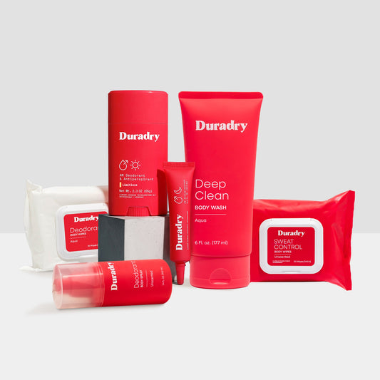 Duradry Signature Starter Kit with skincare products, including bottles and tubes arranged on a clean surface.