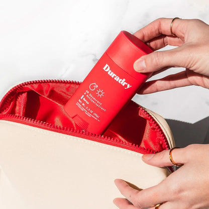 Duradry signature red travel bag with sturdy handle and zippered compartments, ideal for organizing travel essentials.