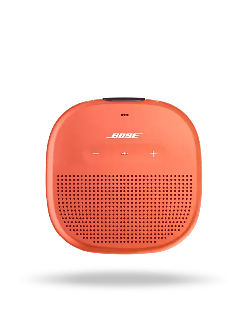 Black Bose SoundLink Micro Bluetooth speaker on a surface, showcasing its compact portable design and built-in speaker grille.