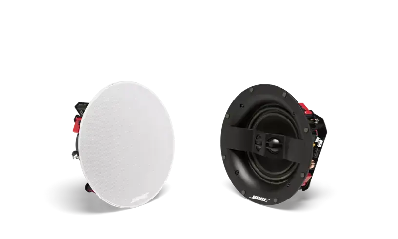 White Bose Virtually Invisible 791 in-ceiling speakers II installed in ceiling for discreet audio coverage.