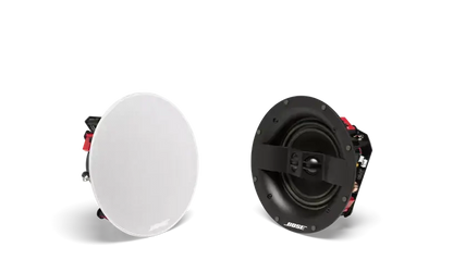 White Bose Virtually Invisible 791 in-ceiling speakers II installed in ceiling for discreet audio coverage.
