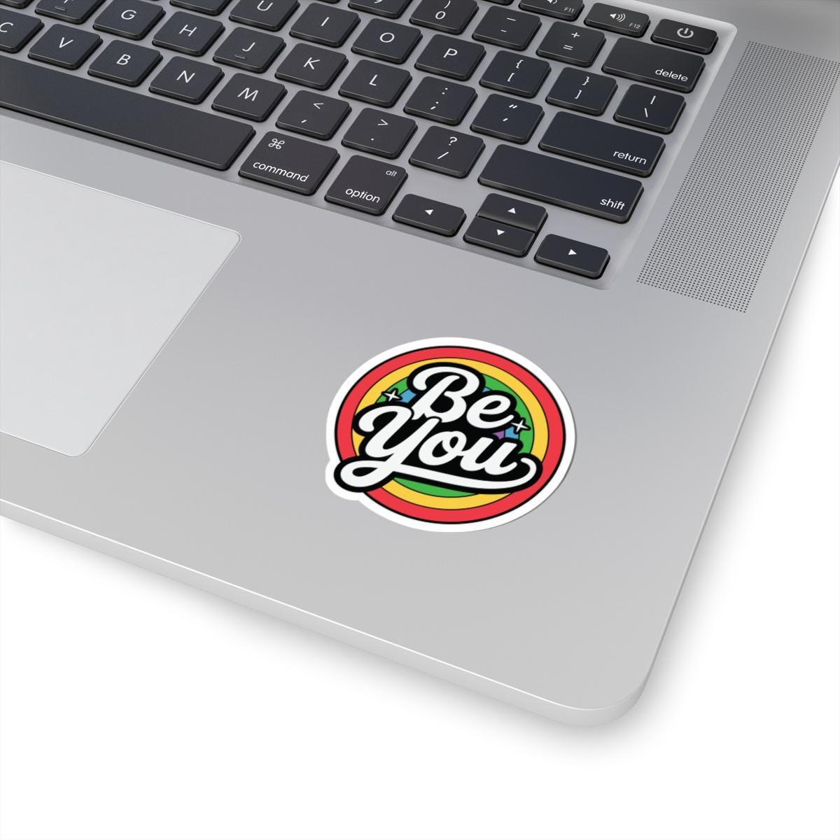 Glossy rainbow sticker with "Be You" message, LGBTQ+ pride vinyl decor, bright colors, and a shiny finish.