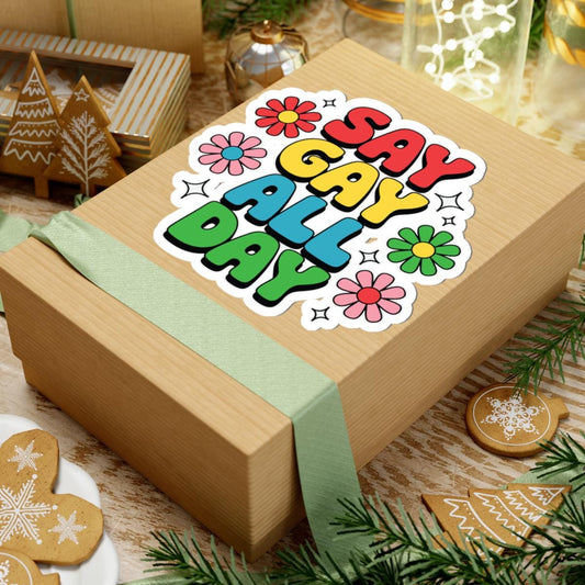 Colorful retro rainbow "Say Gay All Day" LGBTQ pride vinyl sticker on clear backing, ideal for decorating laptops or water bottles.