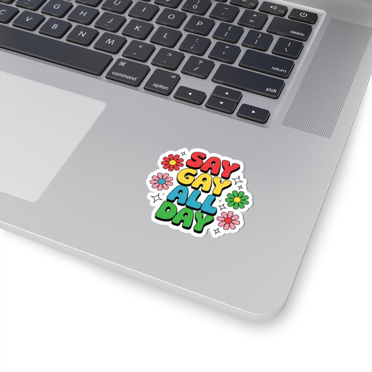 Glossy vinyl LGBTQ pride sticker with retro rainbow design reading "Say Gay All Day," ideal for decor or personal items.