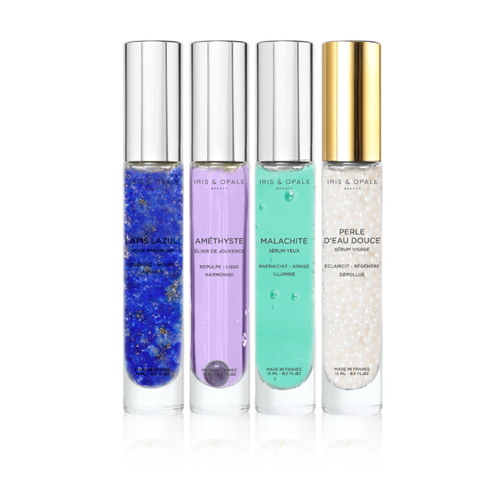 Set of four amethyst serums in IRIS & OPALE's COFFRET L'ALCHIMIX n°1 – Complet, featuring glass bottles with dropper caps.