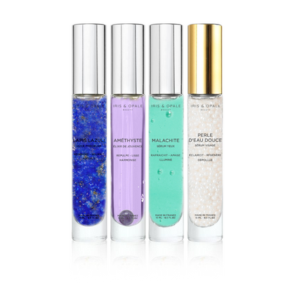 Set of four amethyst serums in IRIS & OPALE's COFFRET L'ALCHIMIX n°1 – Complet, featuring glass bottles with dropper caps.