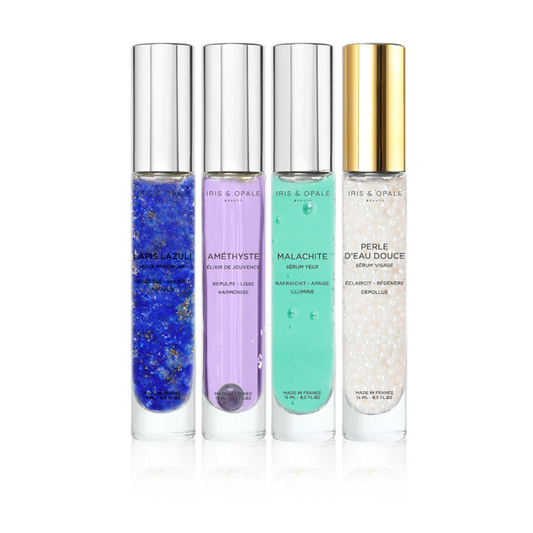 Set of four amethyst serums in IRIS & OPALE's COFFRET L'ALCHIMIX n°1 – Complet, featuring glass bottles with dropper caps.