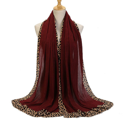 Black leopard-print embellished crinkle hijab scarf by Mariam's Collection, featuring solid color design and decorative details