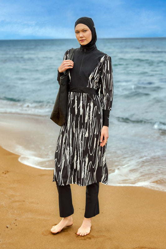 Black full coverage swimwear burkini set by Marina Modest, featuring a modest, long-sleeve design for full body coverage.