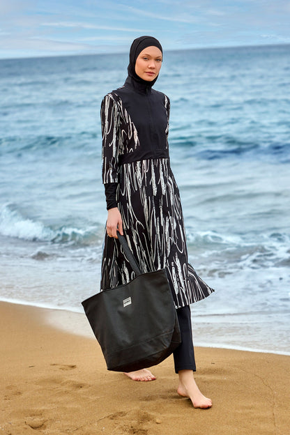 Black full coverage swimwear burkini set by Marina Modest, featuring modest design and full-body coverage for swimming.