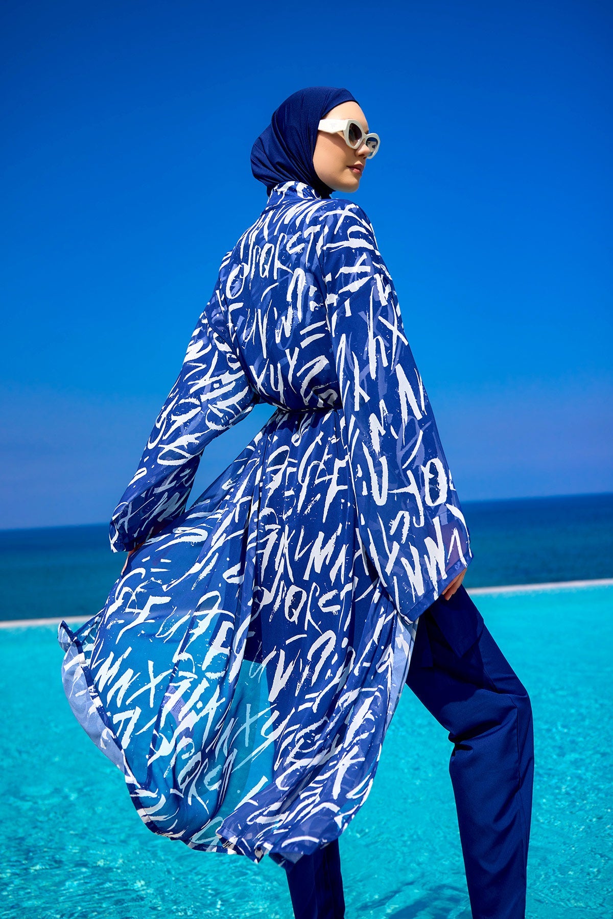 Navy blue full coverage modest swimwear set by Marina Modest, featuring a tam caped design for full sun protection.