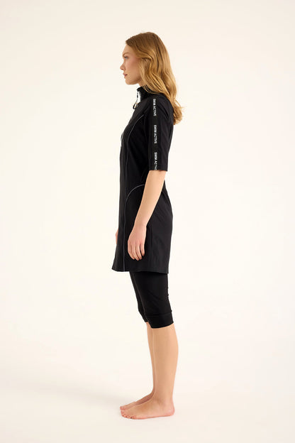 Marina Modest black half-coverage swimsuit for women, designed for modest swimming, featuring a stylish full-coverage design.