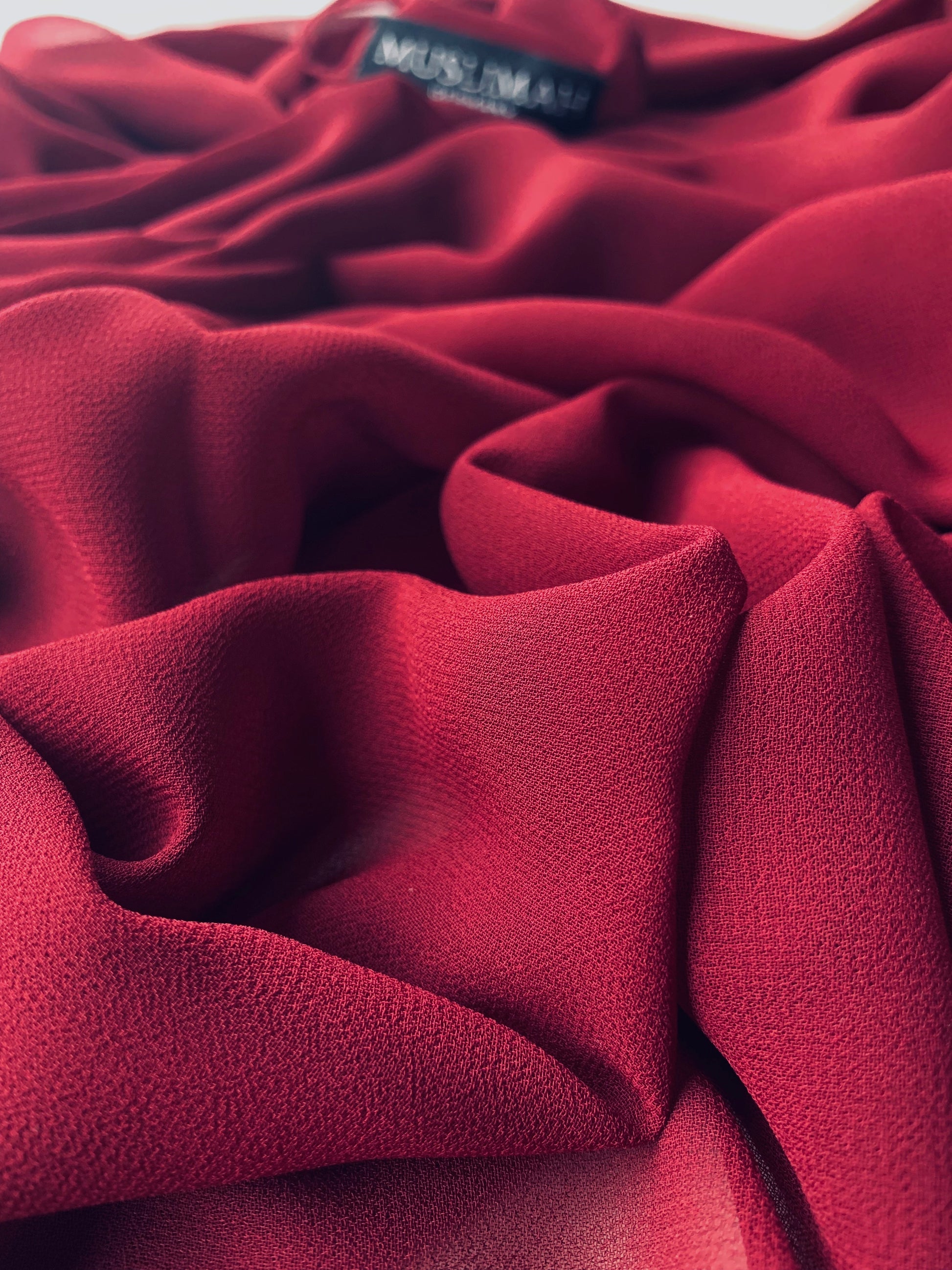 Maroon premium chiffon hijab by Muslimah.de displayed flat, showing its lightweight, flowing fabric and elegant drape.