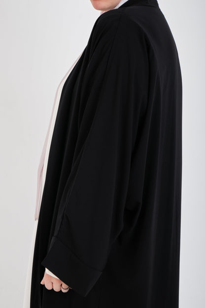 Black Basic Dress from Muslimah.de, featuring a modest, simple design with long sleeves and a flowing silhouette.