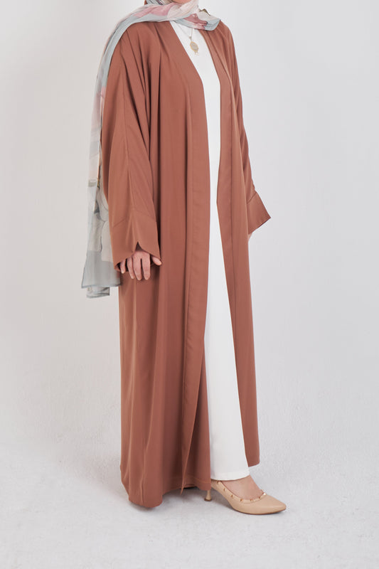 Brown kimono from Muslimah.de with flowing fabric and intricate details, showcasing elegant modest fashion.