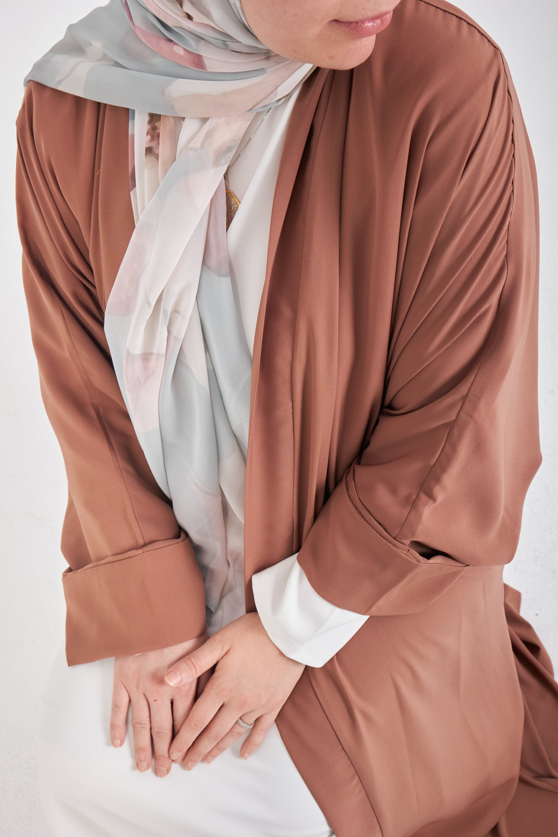 Brown kimono with intricate patterns, lightweight fabric, worn by Muslimah.de, displayed on a plain background.