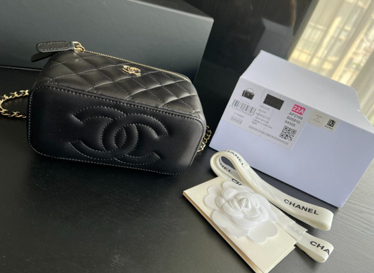Chanel black quilted vanity mini crossbody bag with gold hardware, compact and stylish for elegant everyday wear.