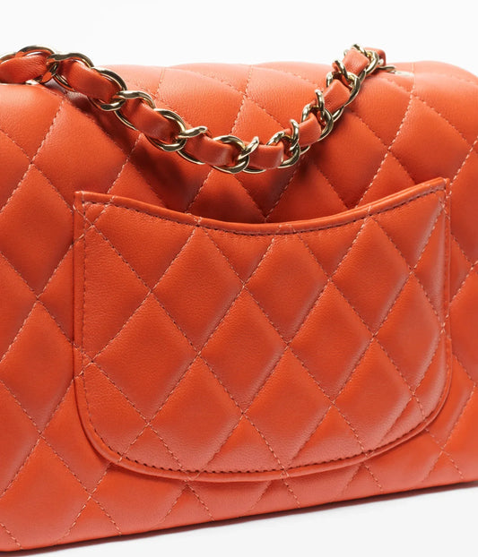 Chanel Bold & Beautiful lambskin and gold-tone metal bag in dark orange with elegant design and structured silhouette.