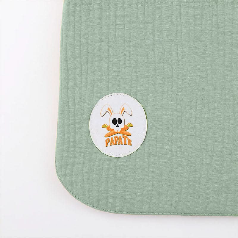 Green organic cotton bib from PAPATE, soft and absorbent baby bib with adjustable neck closure.