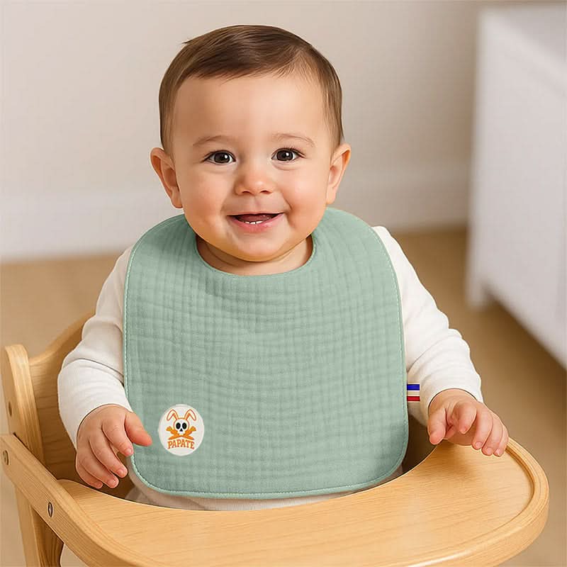 Organic cotton bib by PAPATE featuring a vibrant green color, designed for babies and made from soft, eco-friendly material.