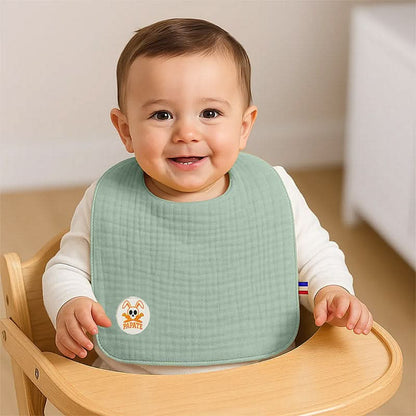 Organic cotton bib by PAPATE featuring a vibrant green color, designed for babies and made from soft, eco-friendly material.