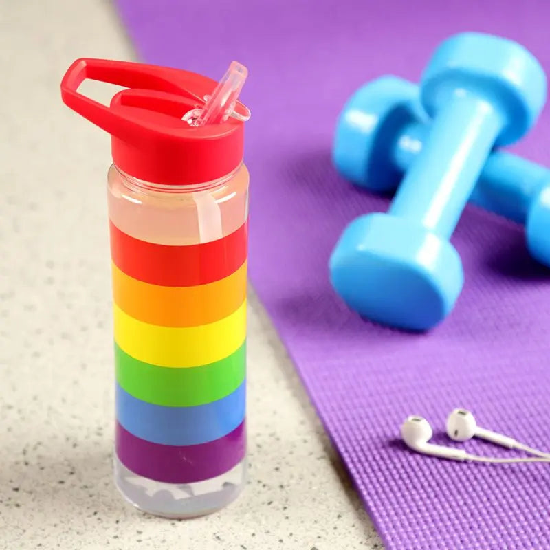 Colorful rainbow 550ml reusable water bottle from Proud Supplies with a flip straw for easy drinking.