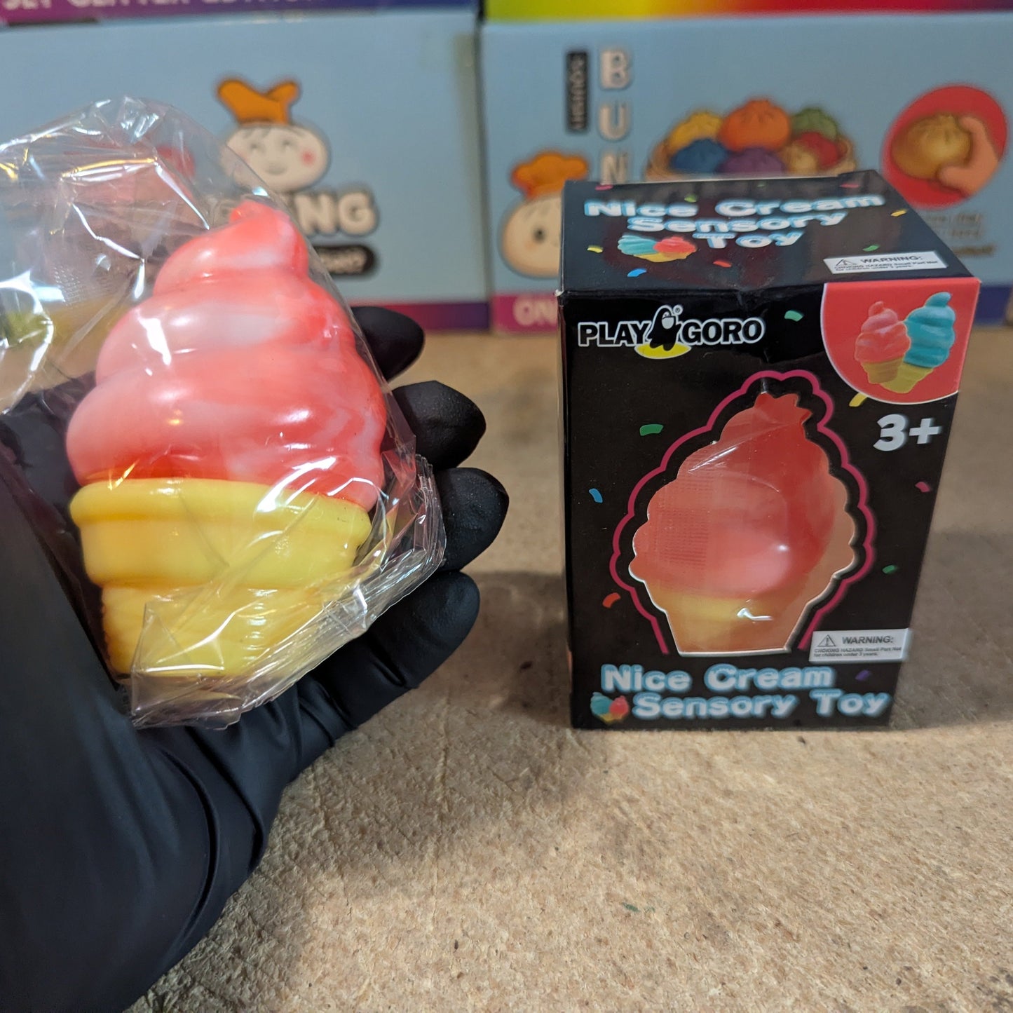 Blood orange creamy ice cream cone squishy from Ralphie's Funhouse, slow rising and soft, realistic dessert replica toy.
