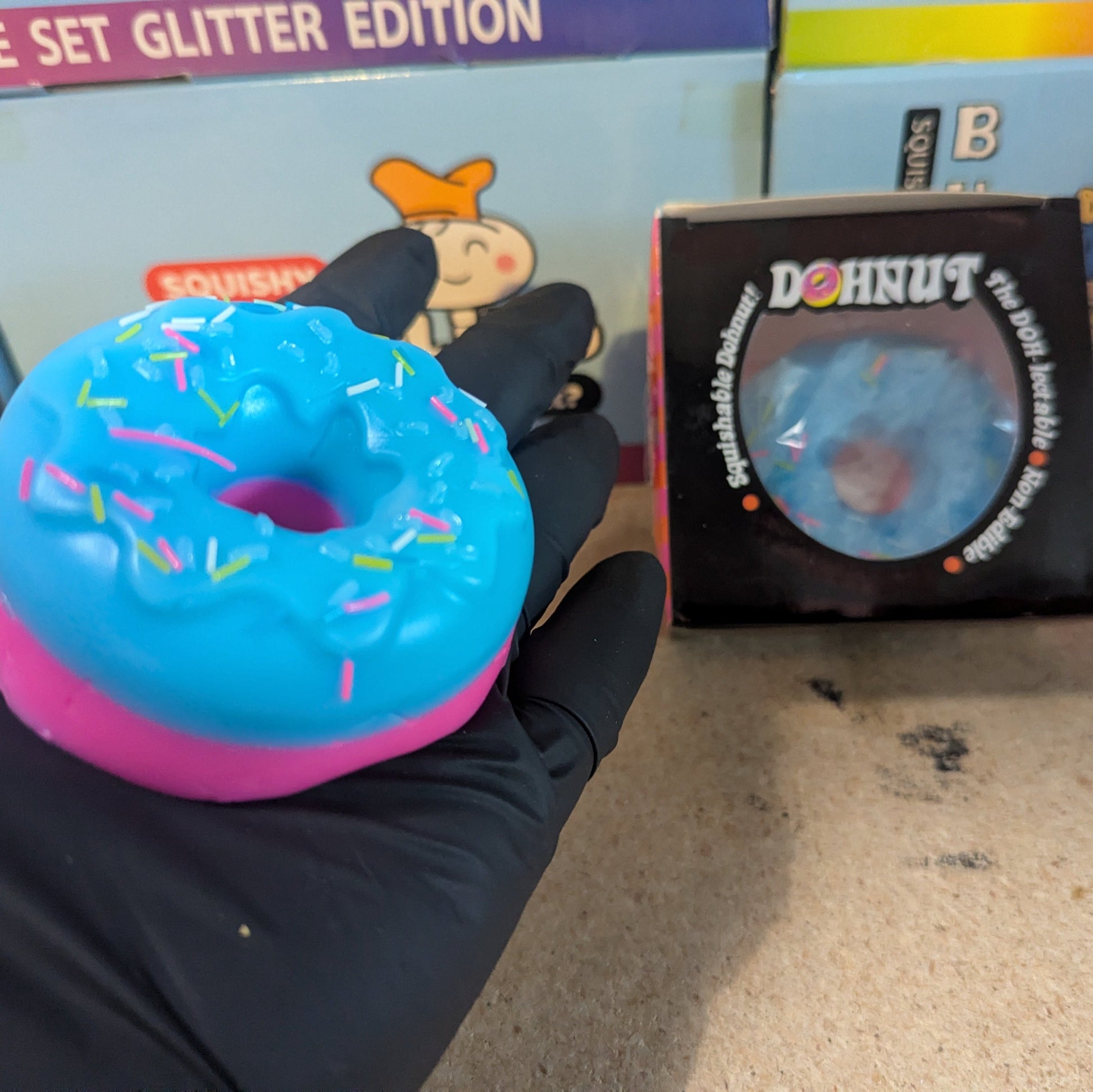 Blue and pink gelatin squish doughnut toy from Ralphie's Funhouse, soft and squishy with colorful detailing.