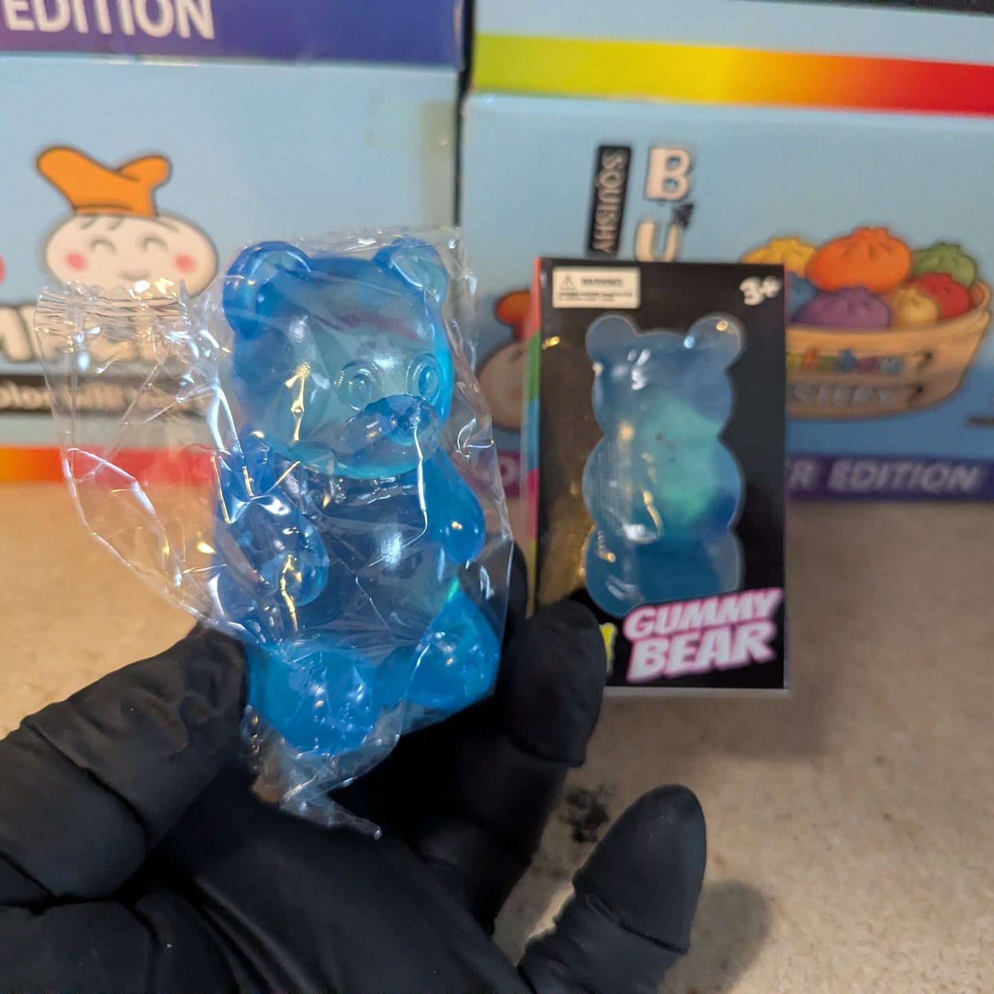 Blue Gummy Bear Squish toy from Ralphie's Funhouse, a slow-rising plush stress relief squish with a soft, textured surface.