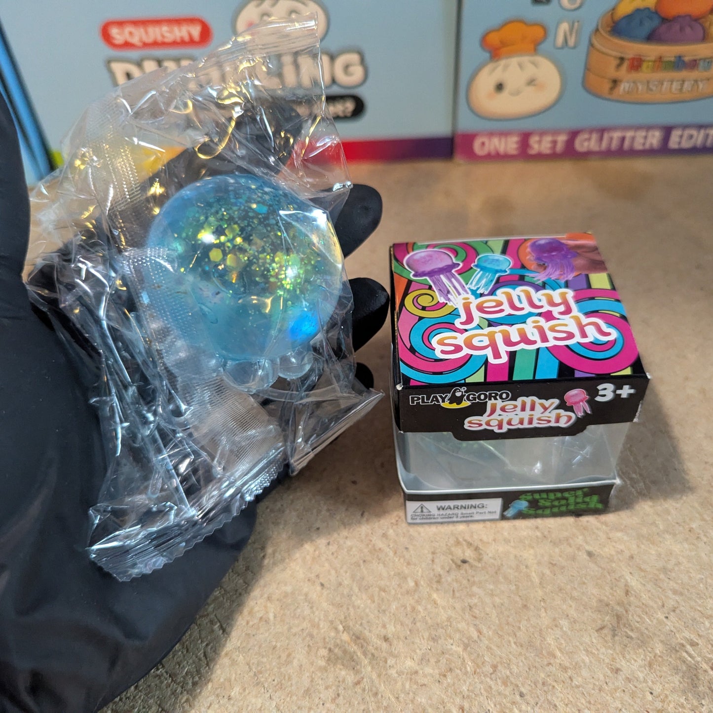 Blue jellyfish slow-rising squish toy with tentacles from Ralphie's Funhouse, soft and squeezable for sensory play.