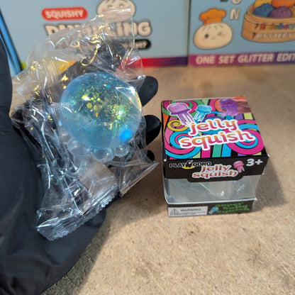Blue jellyfish slow-rising squish toy with tentacles from Ralphie's Funhouse, soft and squeezable for sensory play.