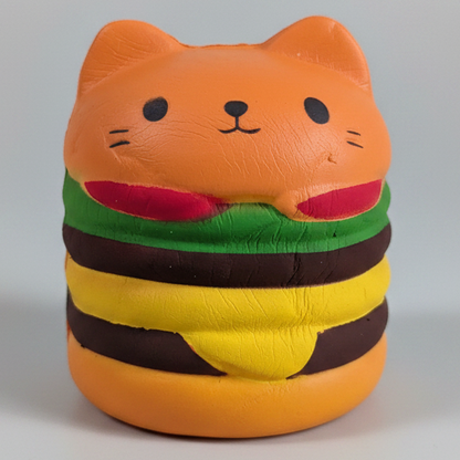Cheeseburger cat squishy from Ralphie's Funhouse, a slow-foam stress relief toy resembling a cheeseburger with a cat shape.