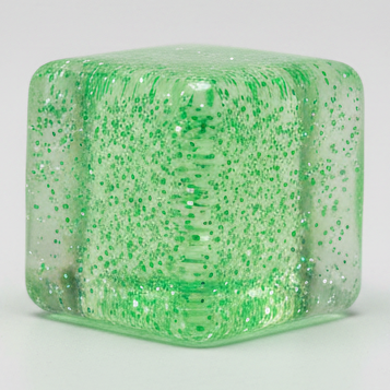 Green translucent glitter mini magic cube by Squeeze Toys, slow-rising squish toy from Ralphie's Funhouse, with a sparkly, textured surface.