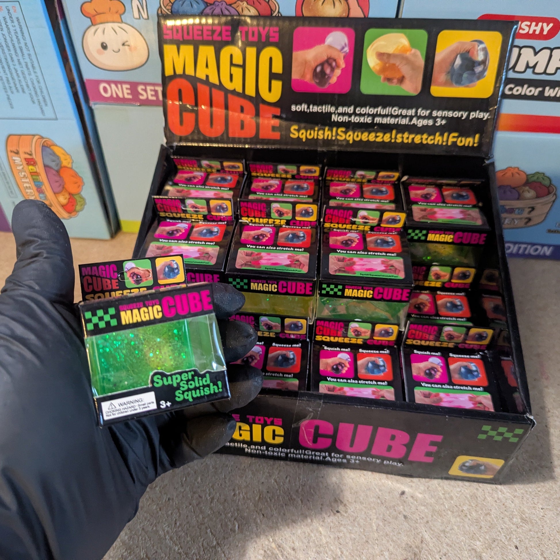 Green translucent glitter mini magic cube by Squeeze Toys, a slow-rising squish toy with sparkling glitter and soft, flexible texture.