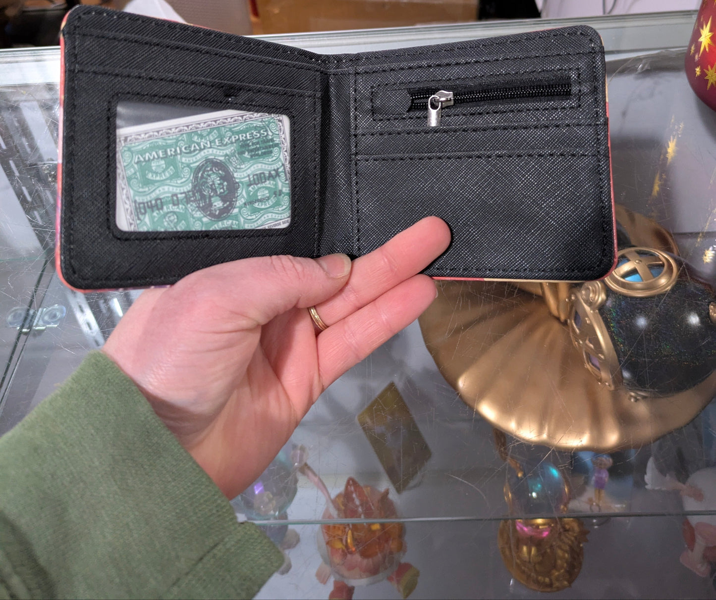 K-POP DEMON HUNTERS Wallet by Ralphie's Funhouse featuring a vibrant trio burst design, showcasing the wallet's colorful pattern and branding.