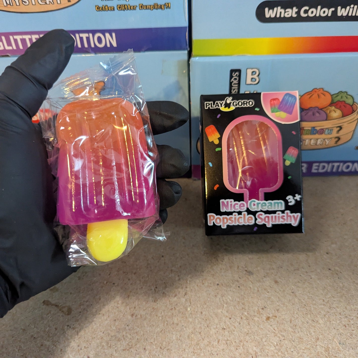 Orange to magenta gelatin popsicle squish toy from Ralphie's Funhouse, soft and squeezable with vibrant color transition.