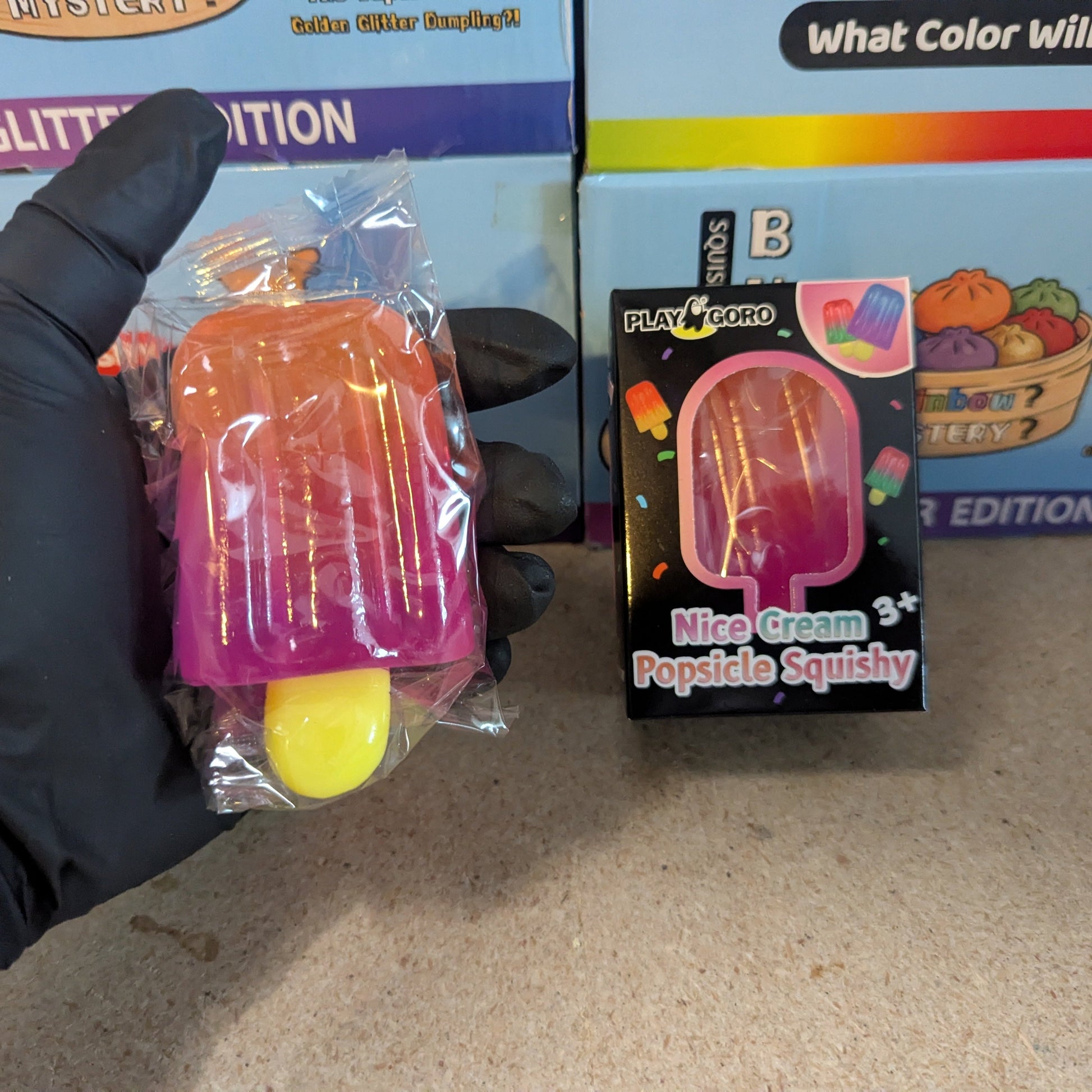 Orange to magenta gelatin popsicle squish toy from Ralphie's Funhouse, soft and squeezable with vibrant color transition.