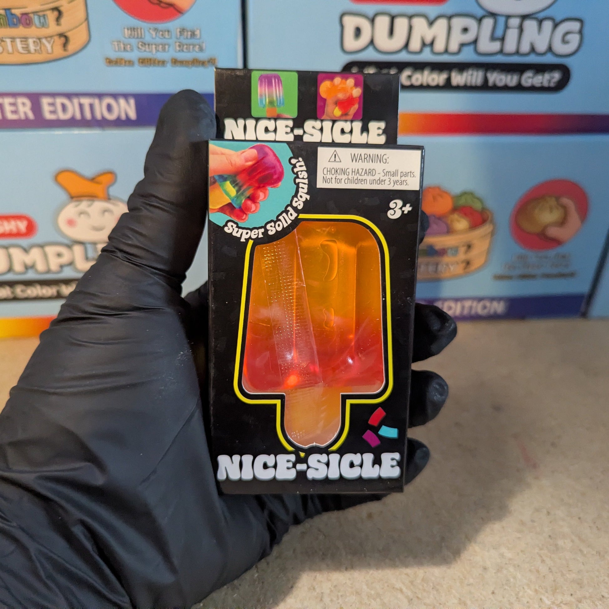 Orange to red gelatin squish toy from Ralphie's Funhouse with a colorful, squishy texture and fun ice cream shape.