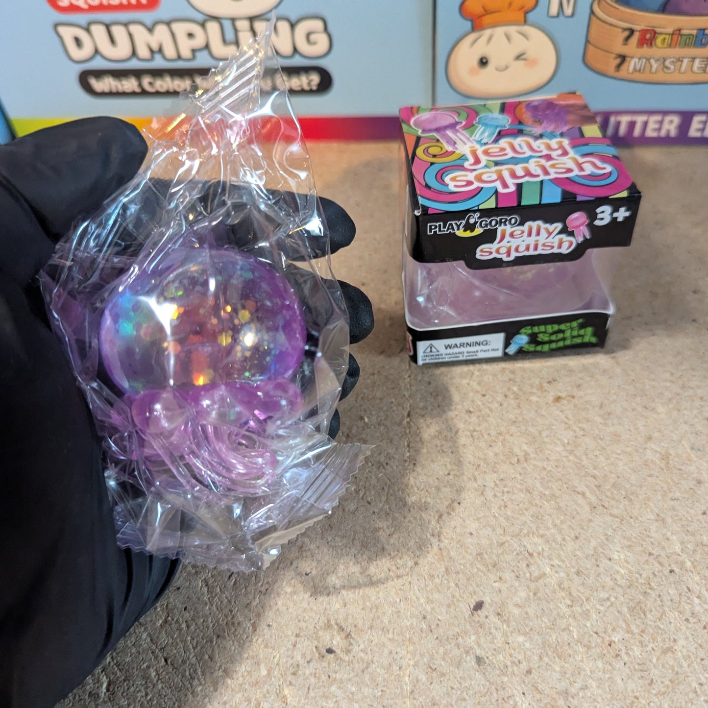 Purple jellyfish slow-rising squish toy with tentacles from Ralphie's Funhouse, soft and squeezable for stress relief.